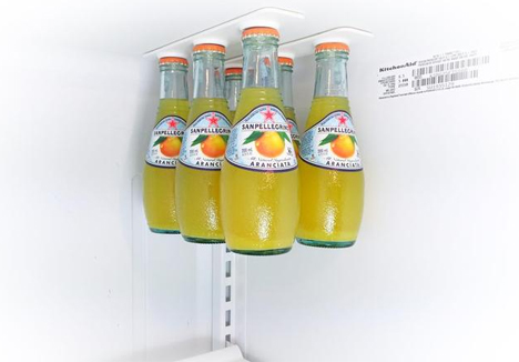 magnetic rails hold drinks off fridge shelves